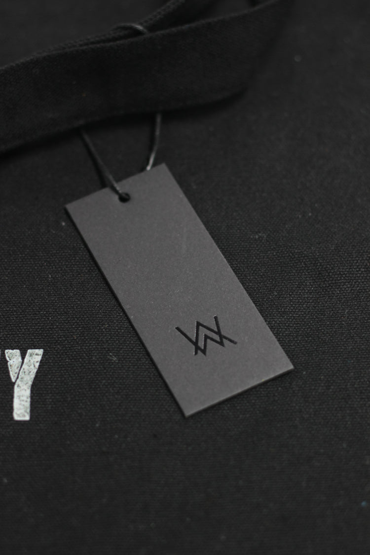 Black tag with a logo on a black background