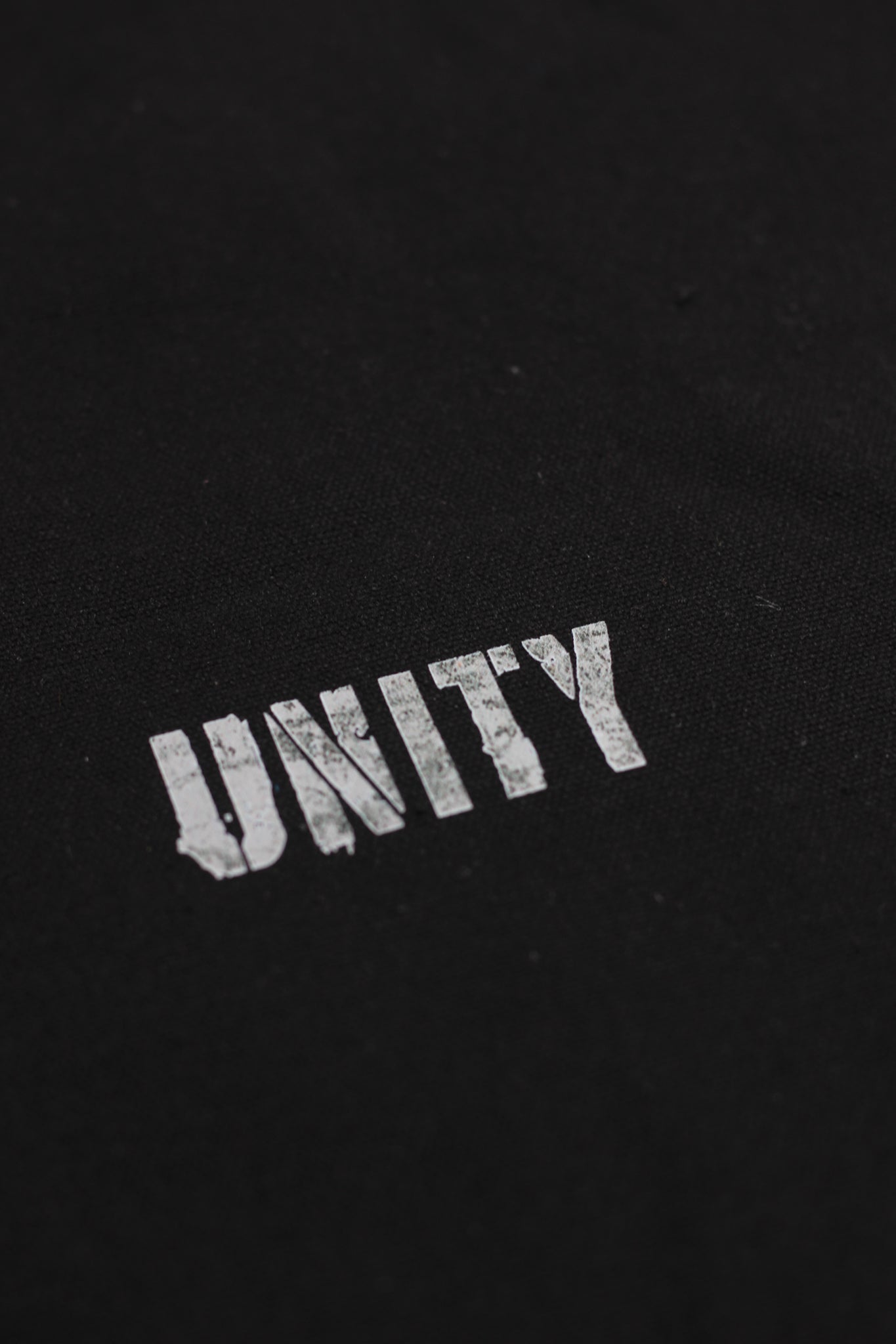 Black fabric with 'UNITY' embroidered in white