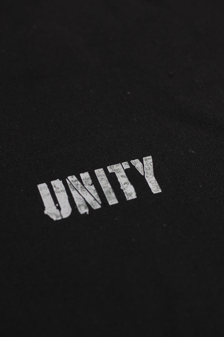 Black fabric with 'UNITY' embroidered in white