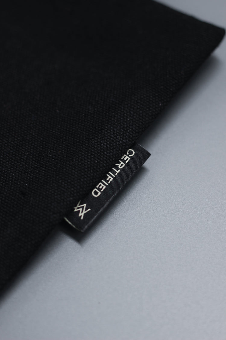 Black fabric with a brand label on a gray background